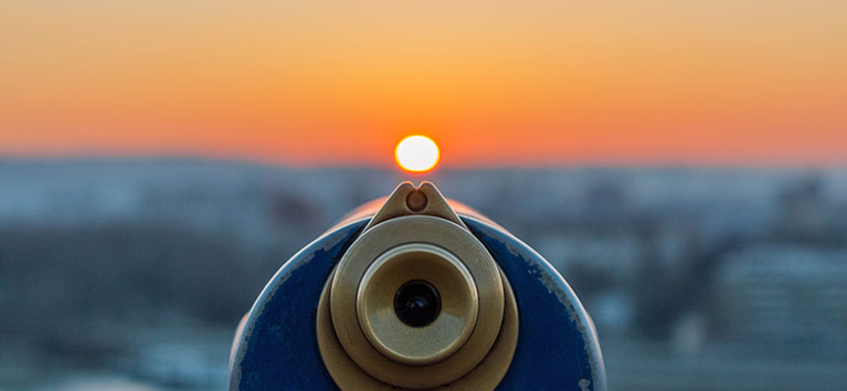 Golden viewer machine looking down at a sunset