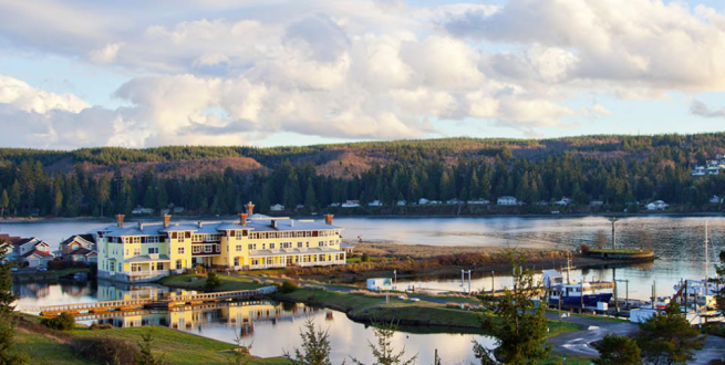 Aerial photo of Port Ludlow with a hotel and harbor in the foreground.