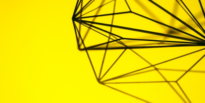 Geometric scuplture with yellow background