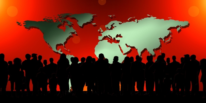 Silhouette of people in front of a world map
